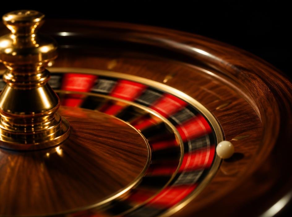 Wooden roulette wheel spinning with the ball in the track